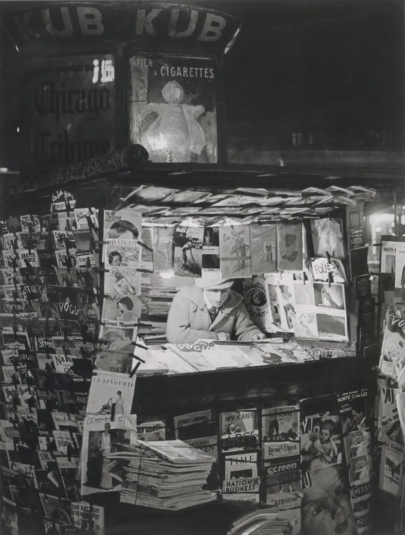 BRASSAI - Newsstand, Paris, 1930: Newsstand, Paris, 1930Photo-litho, c. 2000'sDimensions: 6.3 x 8.4 inchesWork is mounted