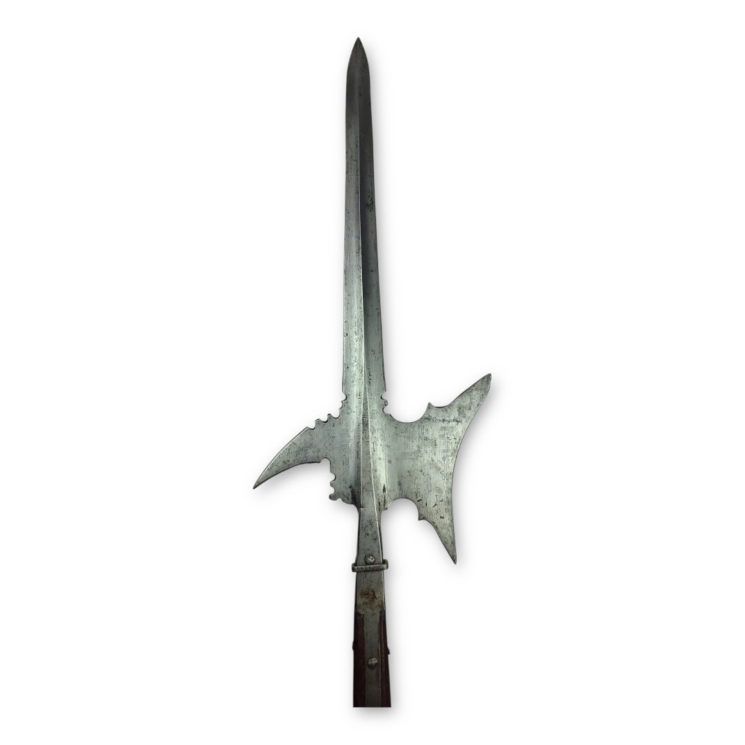 Rare Early 16th Century Halberd, c. 1500–1520 | Visible Blade Markings & Designs: This exceptional early halberd dates to approximately 1500–1520 and exemplifies the transitional martial craftsmanship of late medieval Europe. The head features a prominent sword-shaped spike with
