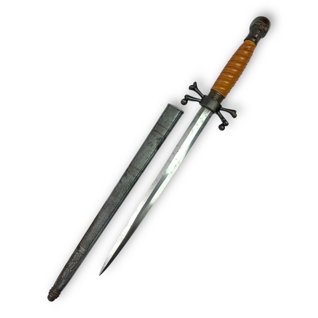 Unusual German WW2 Dagger with Brass Skull and Crossbones Mounts: This rare and visually striking German WW2-style dagger featuring unique brass fittings in the form of skull and crossbones motifs, mounted to both the guard and pommel. Measuring 17.5 inches overall