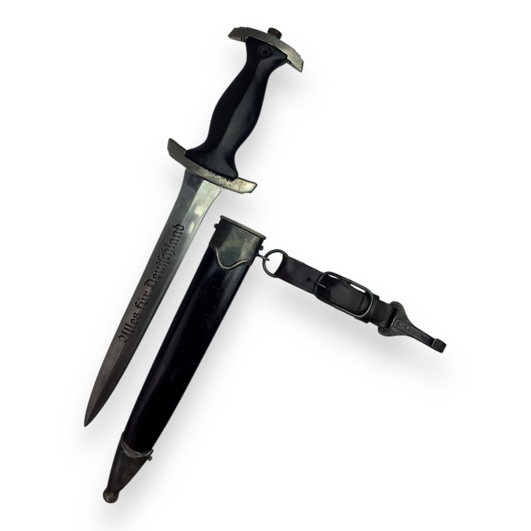 German WW2 NSKK Enlisted Dagger by Gebrüderr Heller (Anchor Logo): This early WWII NSKK dagger is a wartime-issued example crafted by Gebrüderr Heller of Schmalkalden, whose anchor logo is prominently etched on the blade. The wooden grip, once adorned with an SA emb