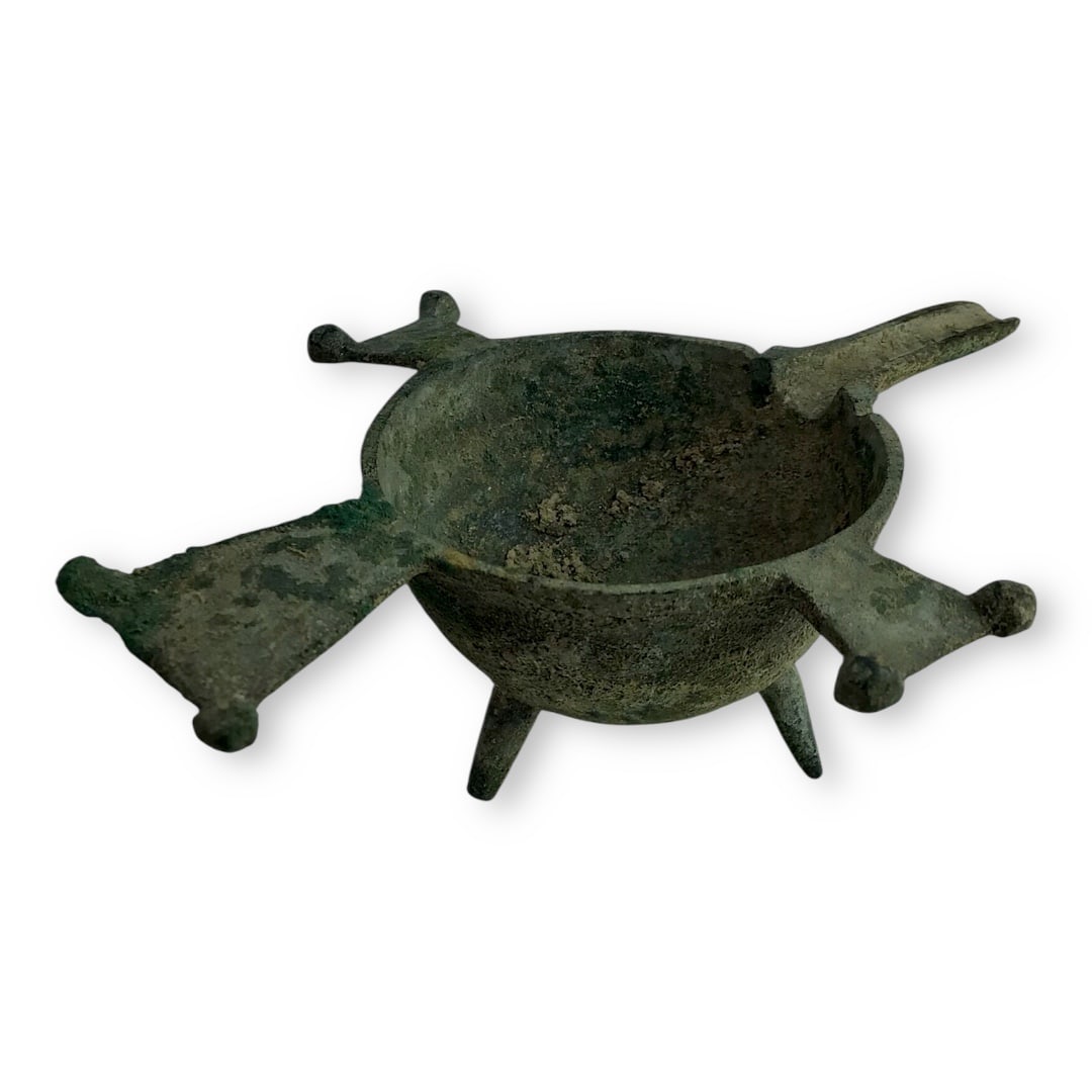 Byzantine Bronze Tripod Oil Lamp Filler with Spout – 4th to 6th Century A.D.: A well-crafted Bronze Oil Lamp Filler from the Byzantine Empire, dating to the 4th-6th century A.D. This elegant vessel features a rounded bowl set on three raised legs, with looped handles on each si