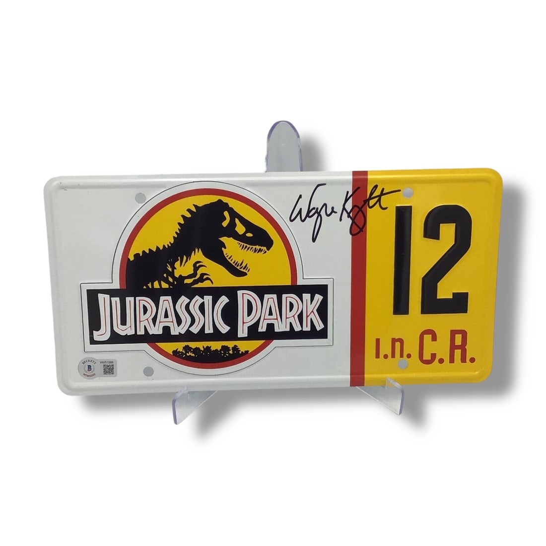 Jurassic Park License Plate | Signed by Wayne Knight (Beckett Certified): Offered here is an official Jurassic Park license plate signed by Wayne Knight, forever remembered as Dennis Nedry, the sly programmer whose sabotage unleashed chaos in Spielberg's 1993 masterpiece. T