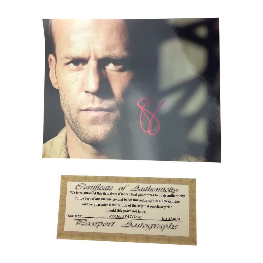 Jason Statham Signed Photograph with COA - Action Film Star: Offered here is a high-quality photograph of Jason Statham, signed boldly in red ink. The image captures the actor in a signature action-ready stance, perfectly reflecting his on-screen persona. Accom