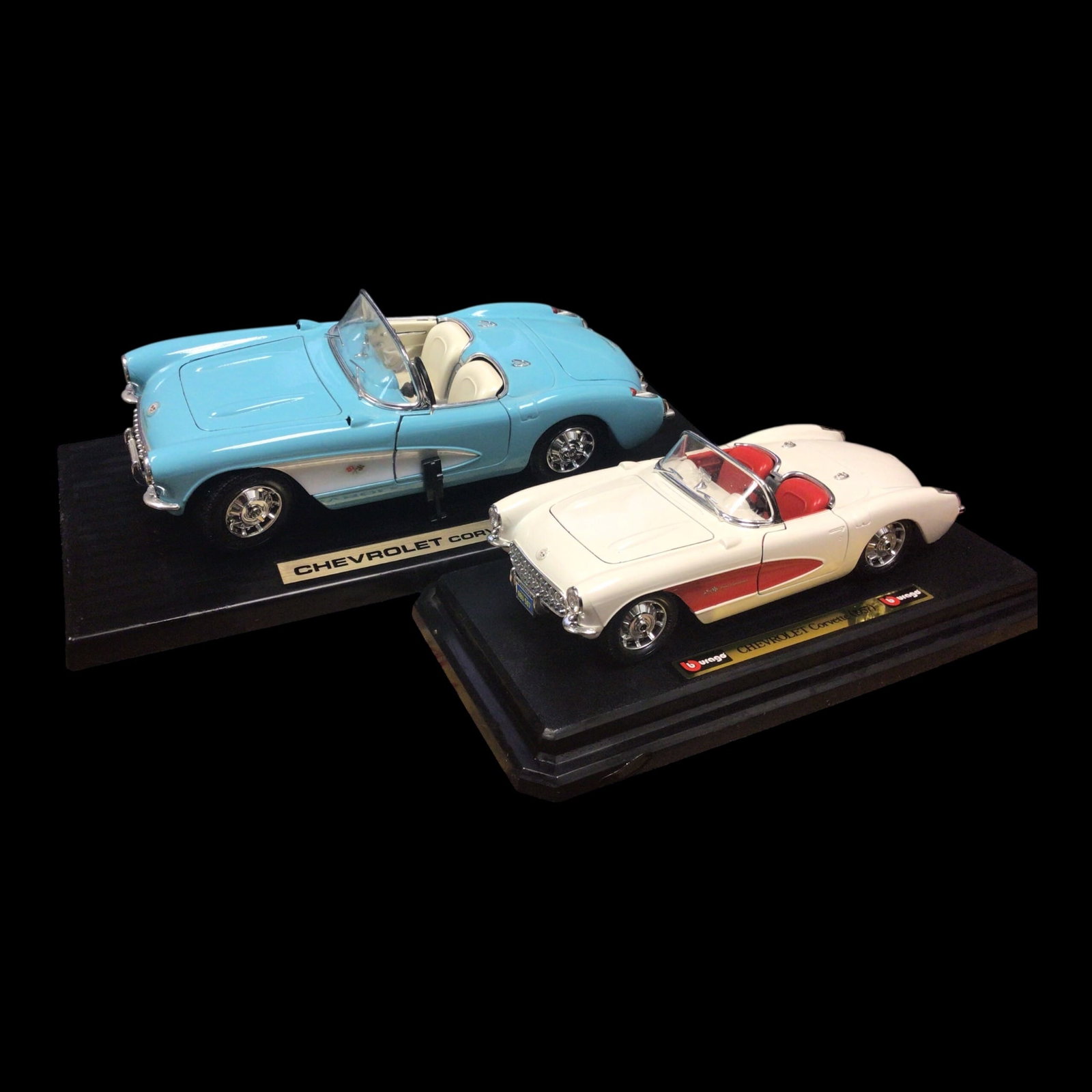 Two Burago 1957 Chevrolet Corvette Die-Cast Model Cars: This elegant duo features two finely crafted Burago die-cast models of the beloved 1957 Chevrolet Corvette: one in a soft sky blue with white interior, the other in classic white with a bold red inter