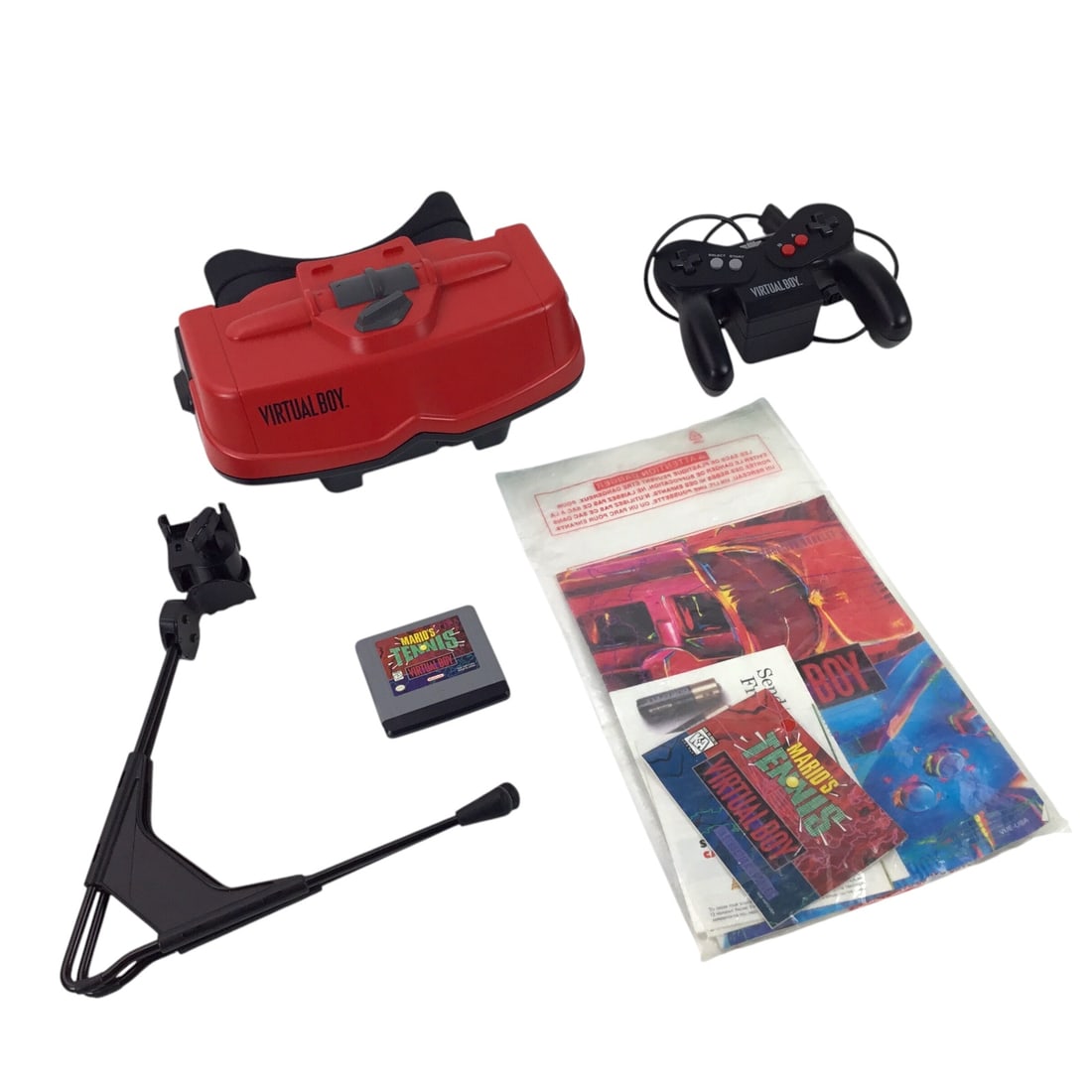 Nintendo Virtual Boy Console in Box with Mario's Tennis - Untested: A boxed Nintendo Virtual Boy console (model VUE-S-RA01), complete with original controller, adjustable stand, Mario's Tennis game cartridge, and factory paperwork. The set appears well-preserved with 