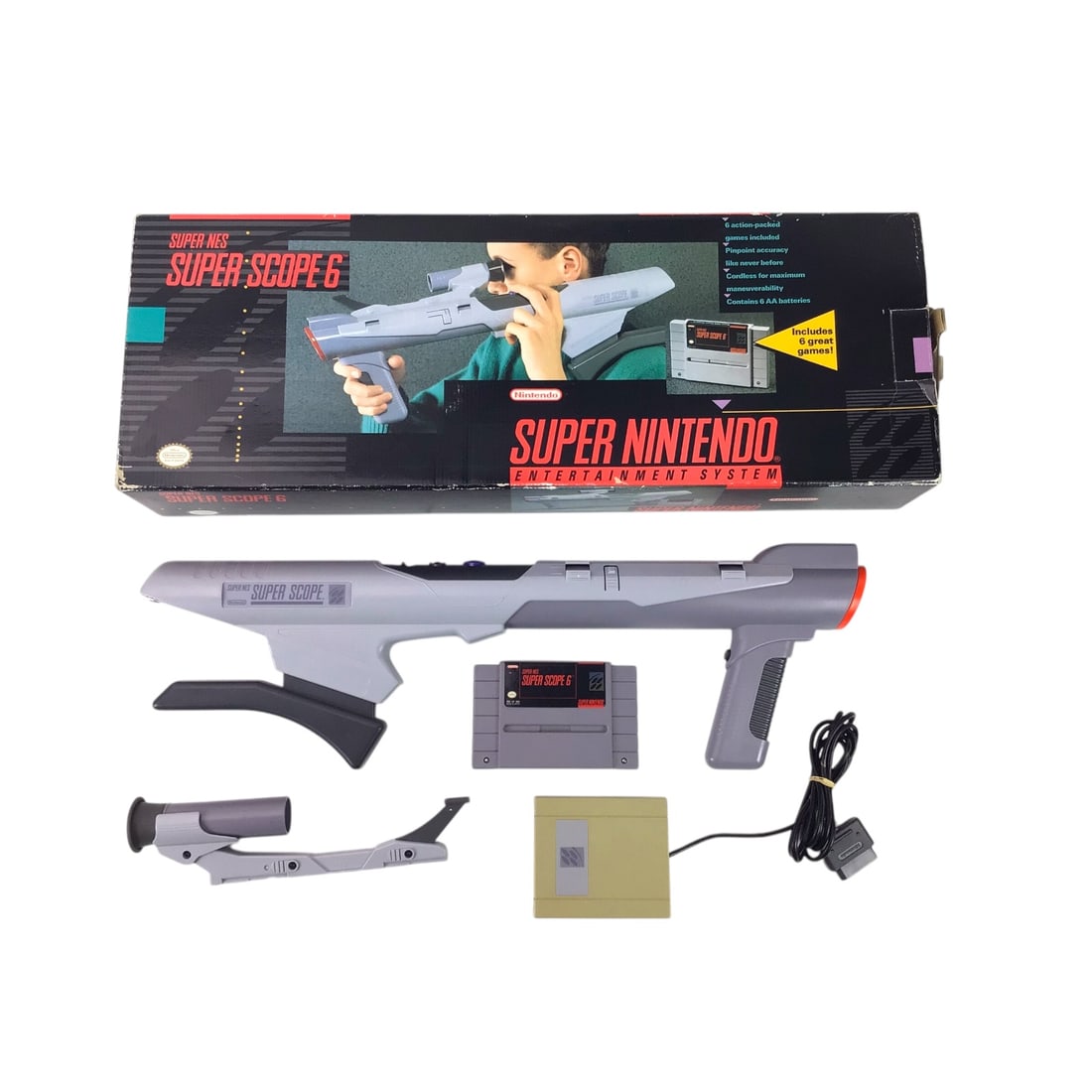 Super Nintendo Super Scope 6 with Box - Untested: Nintendo Super Scope 6 accessory for the Super Nintendo, presented complete with its sensor receiver, Super Scope 6 cartridge, and original retail box. The oversized scope design remains intact, thoug