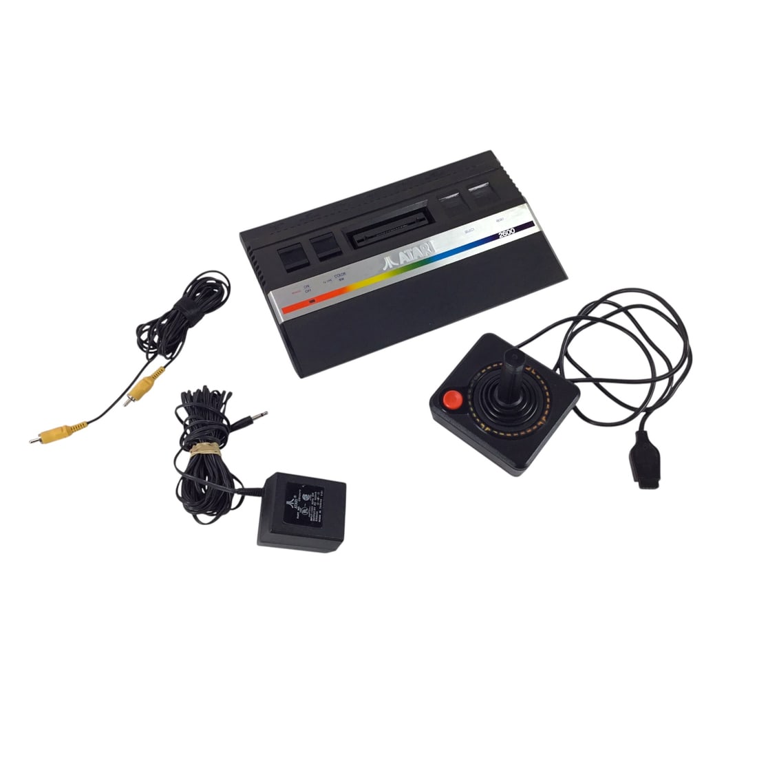 Atari VCS 2600 Console with Joystick & Adapter - Powers On, Untested Further: Classic Atari VCS 2600 console, accompanied by one original-style joystick and power adapter. The system powers on but has not been further tested with cartridges. The console housing shows moderate w