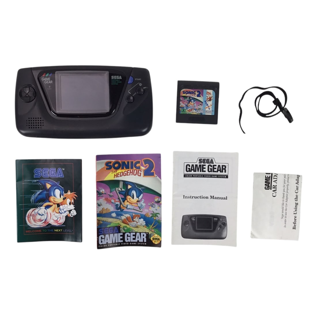 Sega Game Gear with Sonic 2 - In Original Box - Working Condition: Experience 1990s handheld gaming with this Sega Game Gear system, complete in its original retail box. This lot includes the console in working condition, the classic Sonic the Hedgehog 2 game cartrid