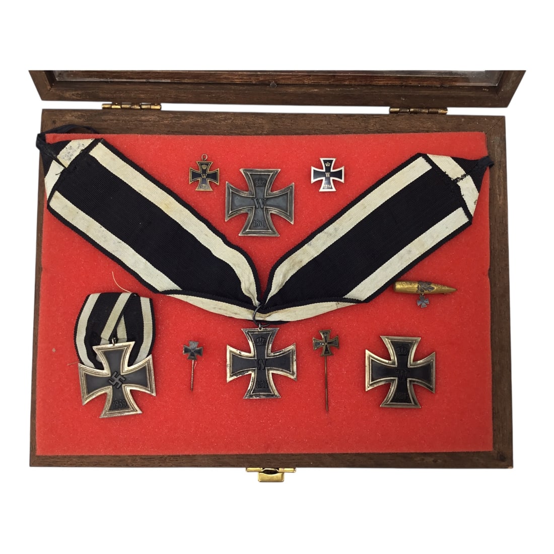 German History of the Iron Cross Collection - Multi-Era Badge Collection in Display Case: This remarkable German History of the Iron Cross collection presents a comprehensive, multi-era grouping tracing the evolution of Germany's most iconic military decoration from the 19th century throug
