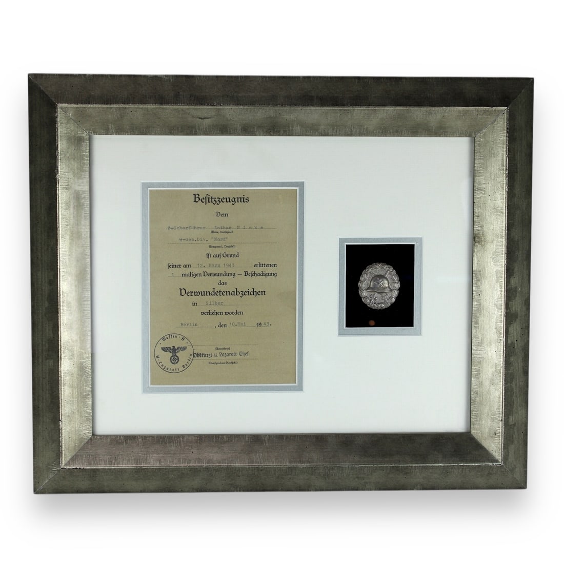 Silver Wound Badge 2nd Class with Award Doc to SS Officer Professionally Framed and Matted: The Wound Badge (Verwundetenabzeichen) was a German military decoration first promulgated by Wilhelm II, German Emperor on 3 March 1918, which was first awarded to soldiers of the German Army who were