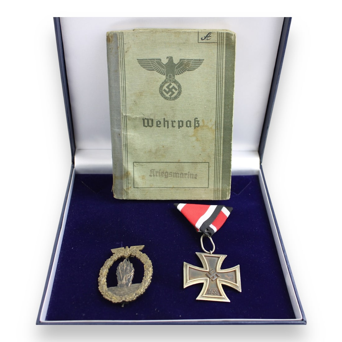 Killed in Action Kriegsmarine Sailor Grouping + German Documents - Wehrpass, Iron Cross, Minesweeper: This exceptionally rare and complete WWII German Kriegsmarine (Navy) KIA Sailor Grouping includes an Iron Cross 2nd Class with ribbon, maker marked Klein & Quenzer and awarded for bravery in combat, a