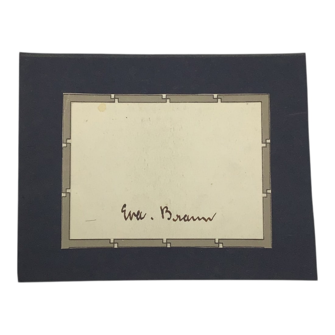 Eva Braun Cut Signature | Rare German Third Reich Signature: This offering features a cut signature of Eva Braun, carefully removed from a document and professionally mounted to a thicker black display board for presentation. The signature itself remains c