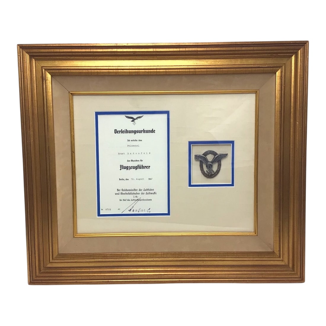 German WW2 Luftwaffe Pilot's Badge with Award Document Professionally Matted and Framed: This WW2 German Luftwaffe Pilot's Badge, awarded to Sergeant Ernst Badenfeld on August 10, 1941, is professionally matted and framed alongside its original award document, signed by Luftwaffe Gen