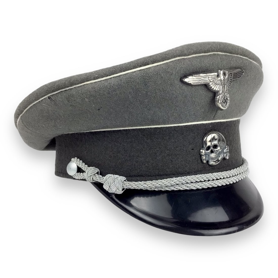 Replica German WW2 SS Officer's Visor Cap with Reichsadler and Totenkopf Insignia: This high-quality replica German WWII SS officer's visor cap is a faithful reproduction featuring the iconic Reichsadler eagle insignia above the Totenkopf death's head emblem. Constructed in gray woo
