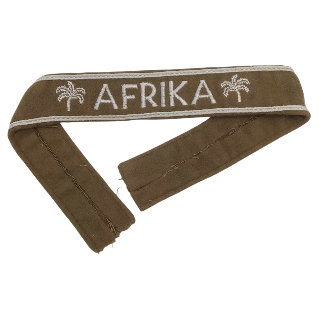 WWII German Afrika Korps (DAK) Cuff Title Arm Band – Near Mint | 1.5" x 15": This outstanding Afrika Korps (DAK) cuff title is a near-mint example with crisp, tight stitching and excellent overall preservation, measuring approximately 1 1/2 inches by 15 inches. The fabric pres