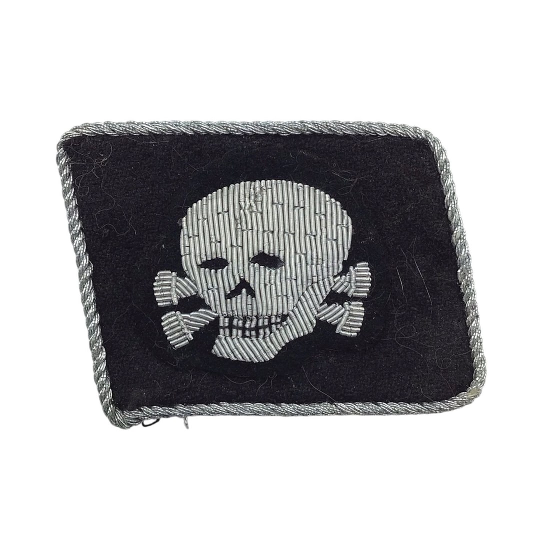 German WW2 SS Totenkopf Officer Collar Tab - 3rd SS Panzer Division: This German WW2 SS officer’s collar tab is a striking example of elite SS insignia from the infamous 3rd SS Panzer Division "Totenkopf". Measuring approximately 1&fr