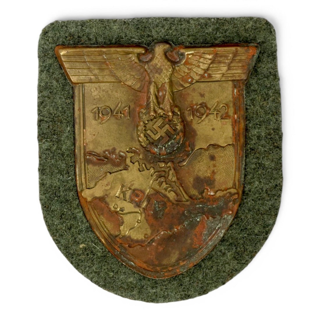 German WW2 Uniform-Removed Heer Crimea KRIM Arm Shield: This original German WWII Army KRIM arm shield, also known as the Crimea Shield, is a uniform-removed example associated with Heer service during the Crimean campaign. The shield would have been worn 