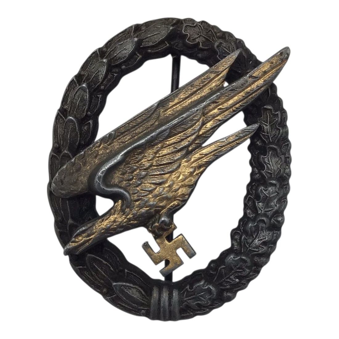German WW2 Luftwaffe Fallschirmjäger Badge by G.H. Osang Dresden: This German WWII Luftwaffe Fallschirmjäger paratrooper badge is maker marked by G.H. Osang of Dresden, one of the recognized manufacturers of Third Reich period awards and insignia. The badge represe