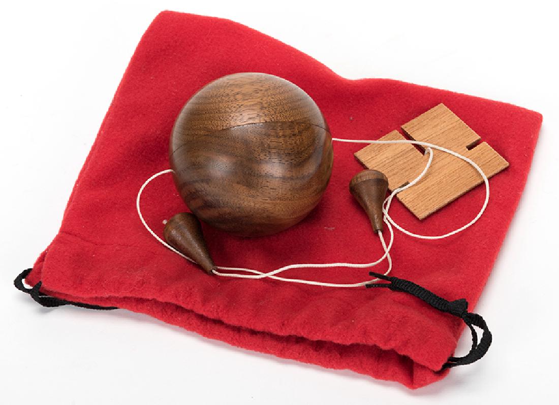 Obedient Ball.: Obedient Ball. Santa Barbara: World of Magic (Bill Adams), ca. 1980. A hardwood ball threaded on a cord travels up and down its length at the command of the magician. Pulley method. 2 ¾" ball. With c