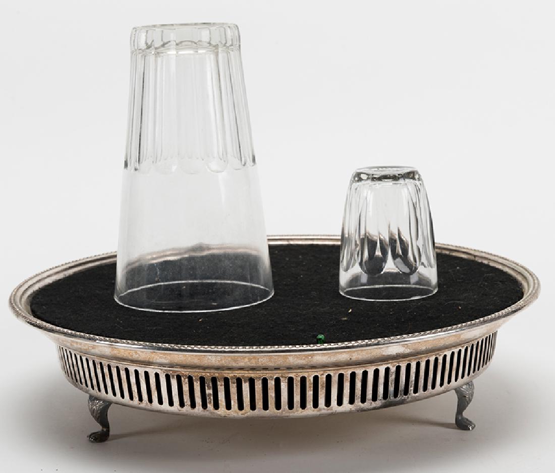 Silver Odyssey I.: Silver Odyssey I. Middleburg: Collectors' Workshop, ca. 1995. Handsome model of Bob Kline's classic Copenetro. Four coins vanish, then visibly reappear in a shot glass covered by a tumbler resting on