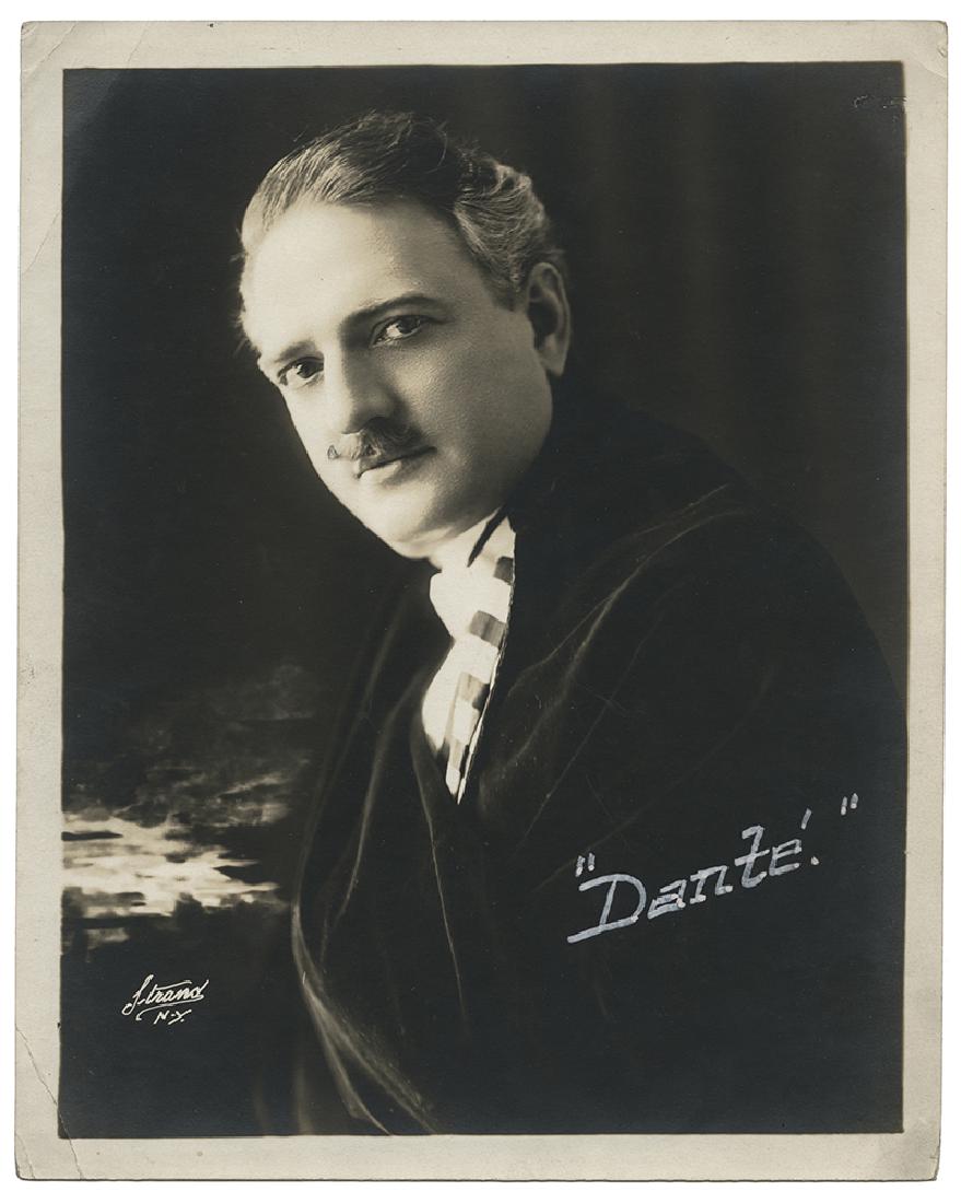 Inscribed and Signed Portrait. Dante.: Dante (Harry August Jansen). Inscribed and Signed Portrait. New York: Strand, ca. 1920s. Sharp double-weight silver print showing a half-length portrait of Dante, inscribed and signed by the magician