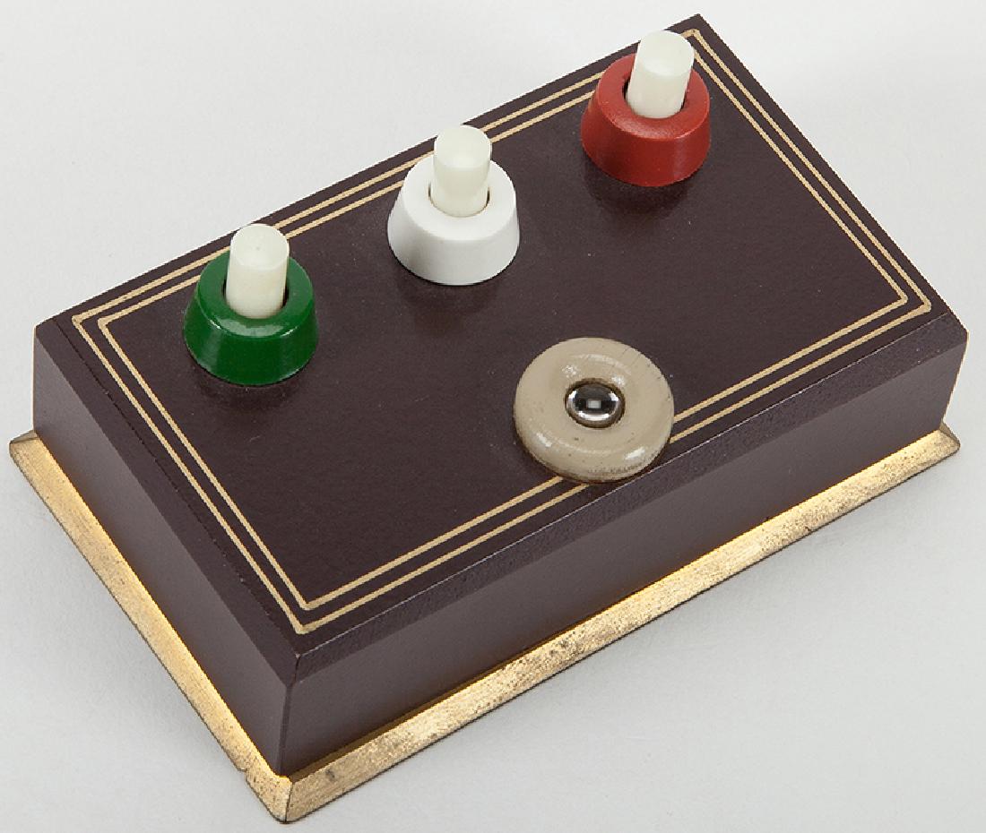 Lucky Light.: Lucky Light. Holland: Eddy Taytelbaum, 1960s. A spectator is asked to guess which of the three switches will cause the light bulb to light up on the wooden box. No matter how many guesses he is given,