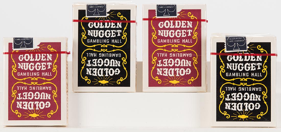 Golden Nugget Gambling Hall Playing Cards.: Golden Nugget Gambling Hall Playing Cards. Las Vegas, ca. 1970s. Four decks, all sealed in original plastic wrapping (bottom edge of plastic wrap to one deck torn but intact). Two red backs, two dark 