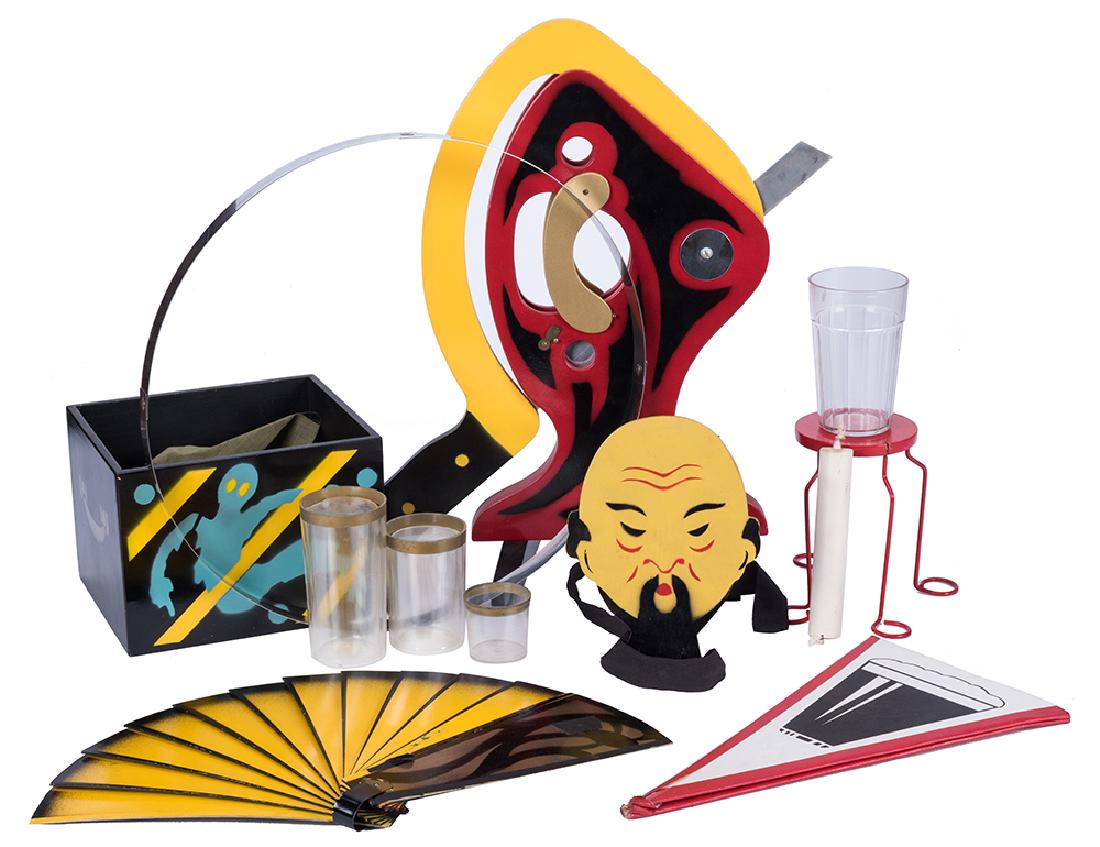 Collection of Abbott’s Magic Props.: Collection of Abbott’s Magic Props. Including Disecto, Flat Beer, Sen-Sashe Glass Vanish, Chinaman Card Rise (imitation after the Abbott’s design), Fantastic Fan, and others. Generally good condit