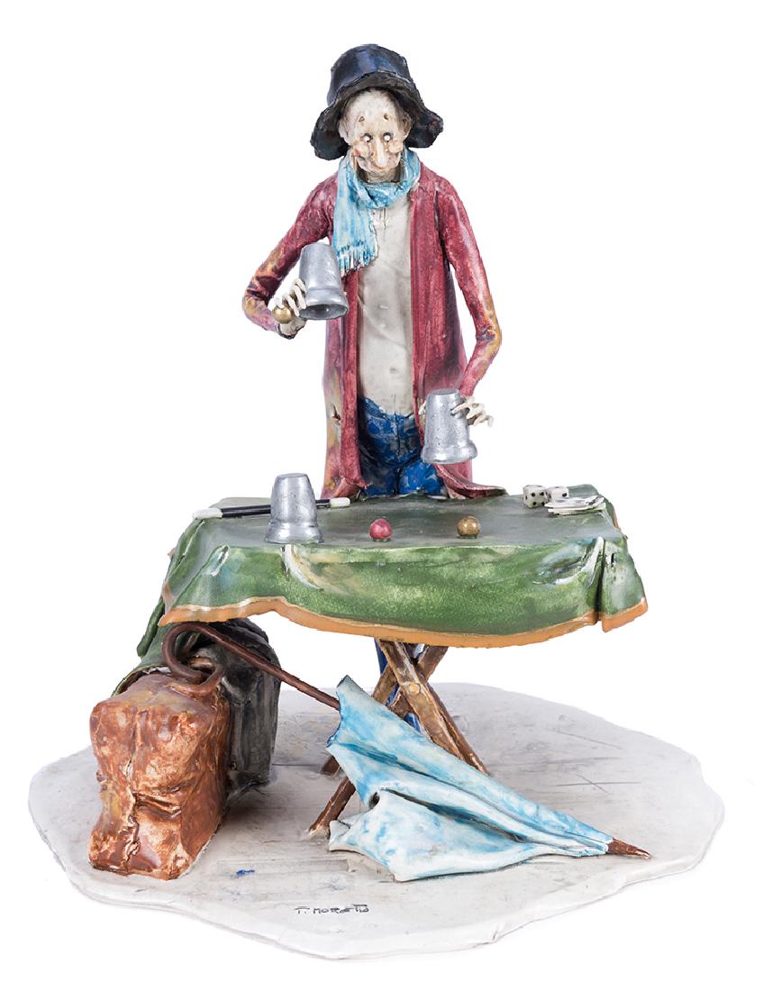 Magician at Table with Cups and Balls.: Moretto, Toni (Italian, 1929–2011). Magician at Table with Cups and Balls. Italy, ca. 1990s. Fired clay sculpture, hand painted, depicting a magician standing before a conjuring table, performing th