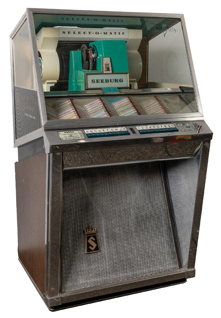 Seeburg 1957 Model L-100 Jukebox (25 Cent).: Seeburg 1957 Model L-100 Jukebox (25 Cent). Chicago, 1957. One hundred 45 RPM selections. Includes many 1950s records. No lock or keys. 53 x 30”. Very good cosmetically.