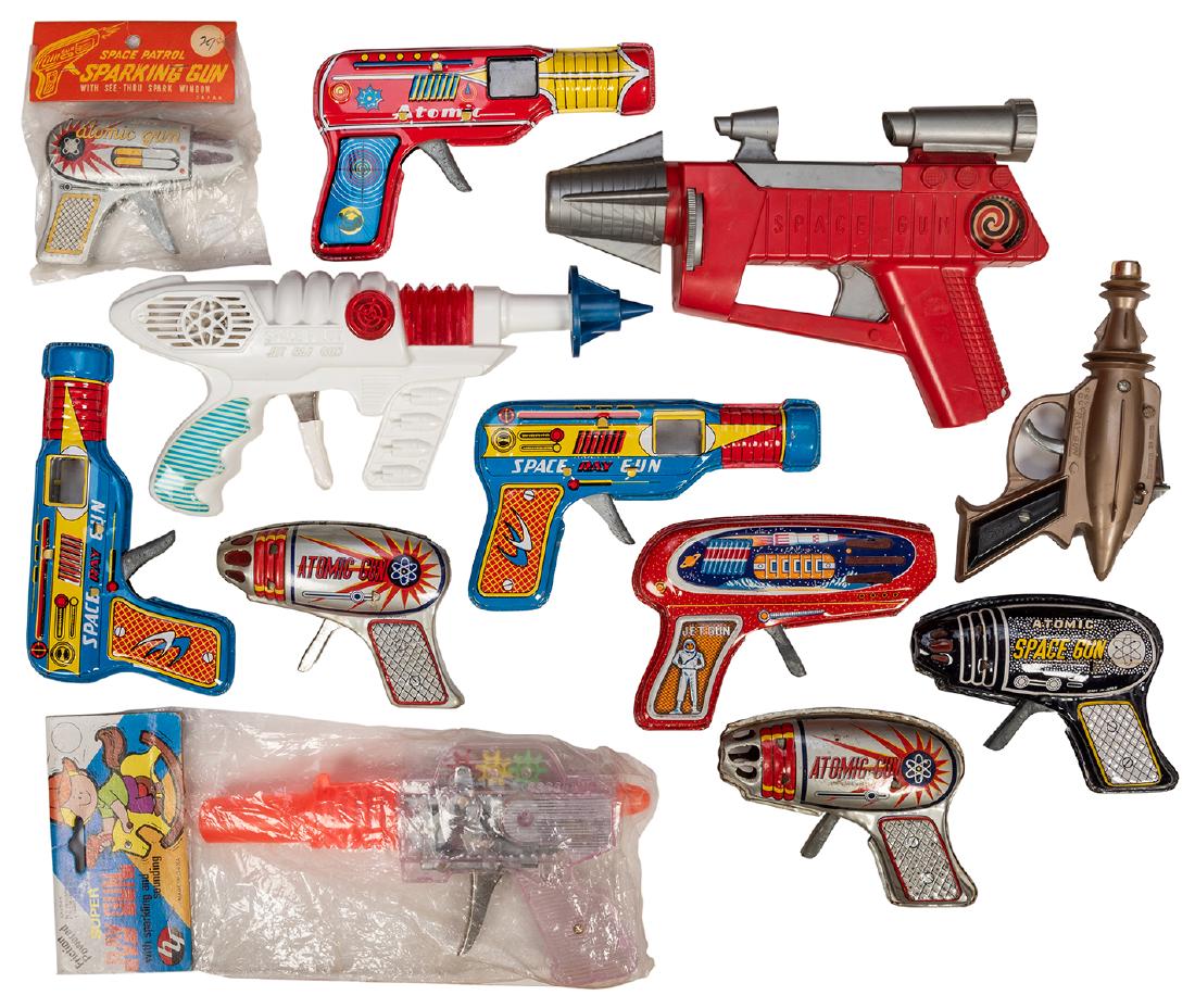 A Dozen Vintage Space Gun Toys.: A Dozen Vintage Space Gun Toys. Japan, Hong Kong, China, ca. 1970s/80s. Plastic and tin litho friction guns and water pistols. One in original packaging.