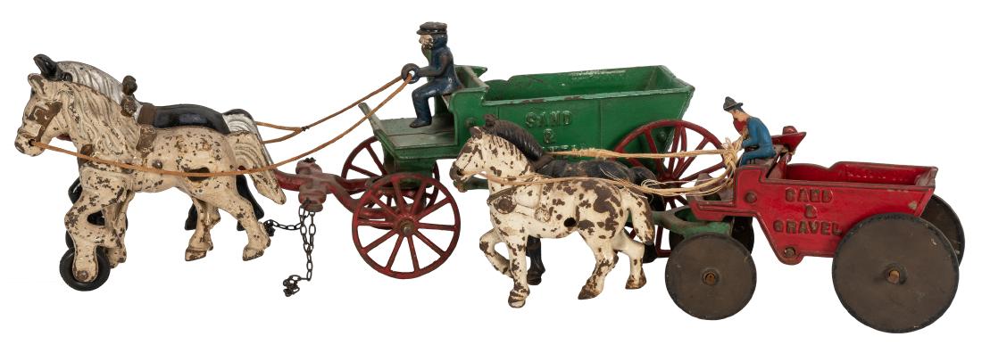 Two Kenton Sand and Gravel Wagons.: Two Kenton Sand and Gravel Wagons. 1920s. Cast iron dump wagon pulled by two horses with driver. Green wagon 14 ½ “ long. Green wagon repainted. Paint chipped, slight soiling. Very good.