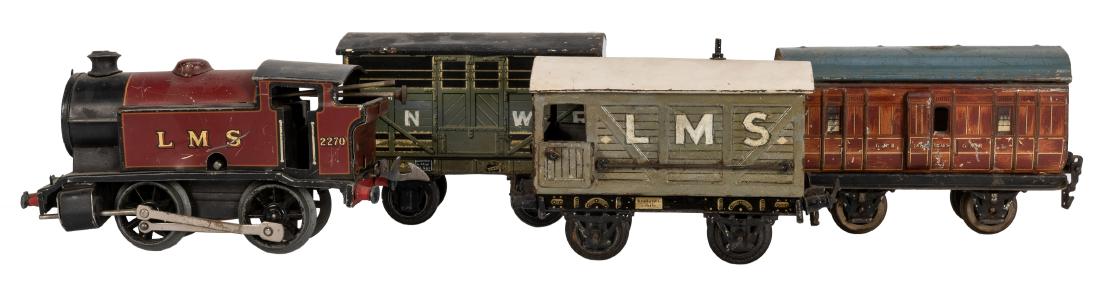 Group of Tin Litho Toy Trains.: Group of Tin Litho Toy Trains. 1930s—40s. Including GNR German made coach car; Basset-Lowke LNWR car; Hornby LMS 2270 locomotive; and Interreg LMS car. Paint chipped and rubbed, scratches. Good.