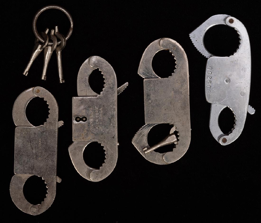 Vintage Thumb Cuffs. Lot of Four.: Vintage Thumb Cuffs. Lot of Four. Manufacturers include Ace (Model 1); Valor Corp (Fla.); MityMite (Serial No. 002498); and Romo (Serial No. 09820). With four keys compatible with two of the cuffs.