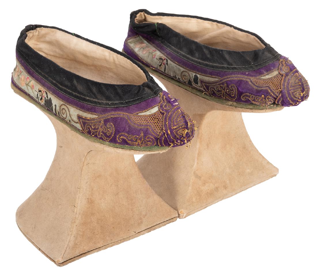 Chinese Chopine Shoes.: Chinese Chopine Shoes. Circa 1900. Primarily purple and black, with embroidered bands of flowers and butterflies, on light green background, with cream colored stands. Good. High platform shoes called