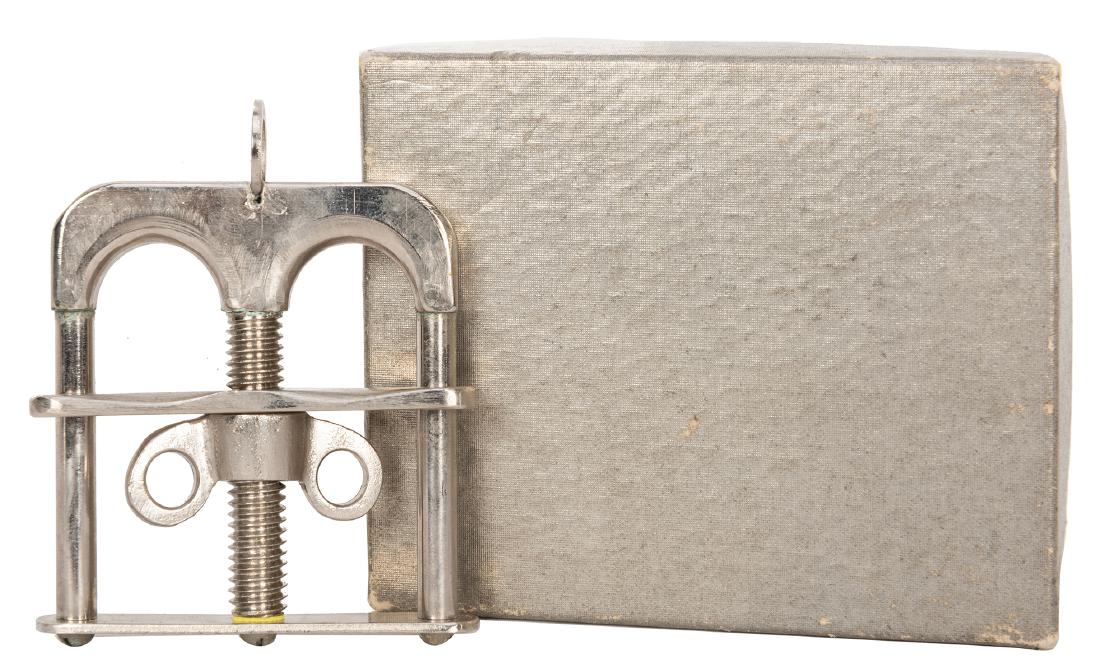 Austrian Thumb Cuffs.: Austrian Thumb Cuffs. Chicago: National Magic, ca. 1940s. Even with his thumbs fastened within the cuffs, the magician passes his arms through solid rings and other objects. Boxed, with original NMC i