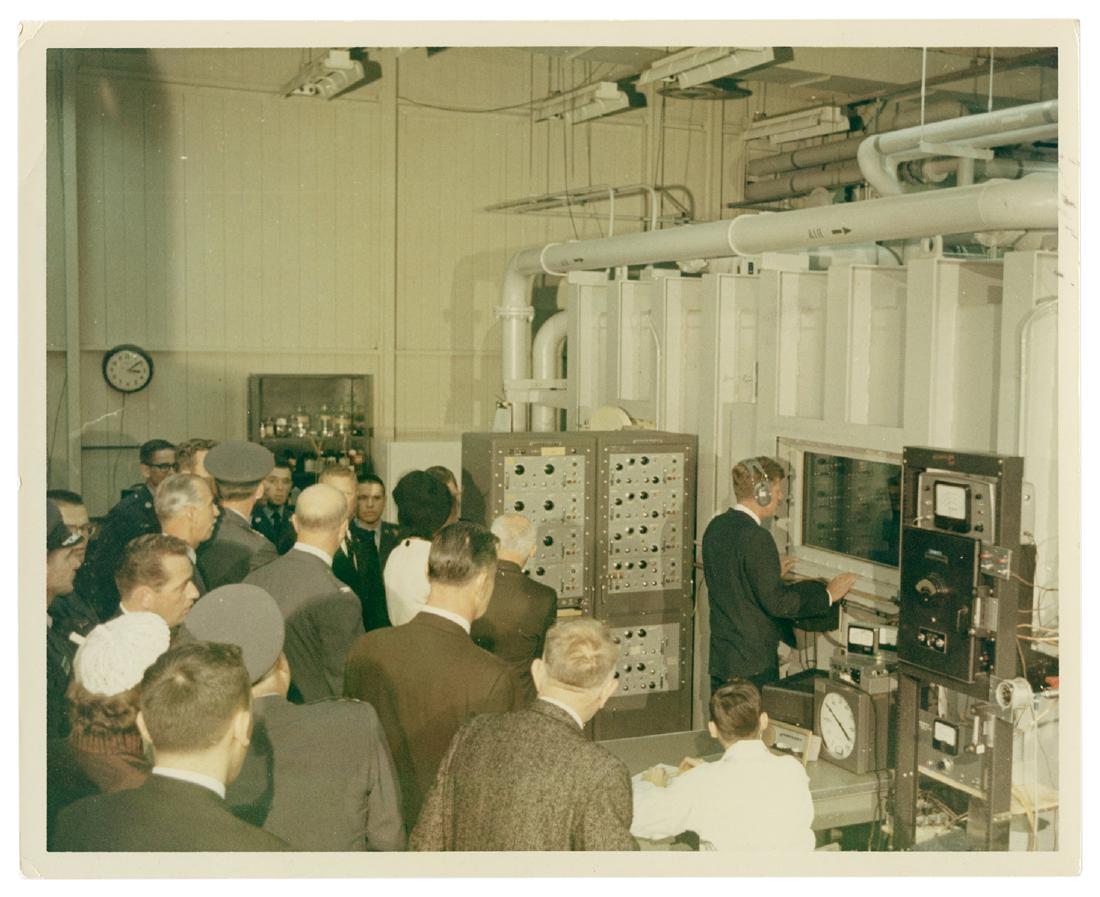 Original Photograph of JFK Touring a NASA Facility.: Kennedy, John F. Original Photograph of JFK Touring a NASA Facility. 1963. Glossy photograph (8 x 10”) by official White House photographer Cecil Stoughton. From Stoughton’s own file, on watermark