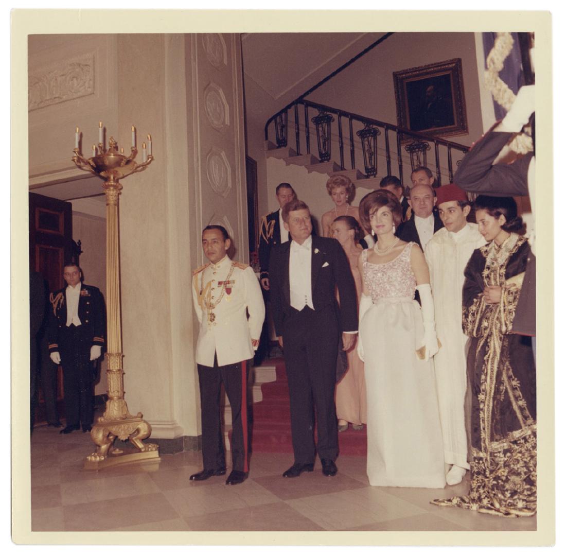 Original Photograph of John and Jacqueline Kennedy with: Kennedy, John F. Original Photograph of John and Jacqueline Kennedy with King Hassan II. 1963. Glossy photograph (5 x 5”) by official White House photographer Cecil Stoughton, showing the Kennedys w