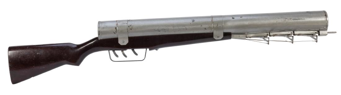 Heckle Gun.: Heckle Gun. North Hollywood: Merv Taylor, ca. 1956. Gigantic comedy prop gun with an oversized barrel. Three triggers are used to fire the weapon, which first shoots one spring snake, then another, an