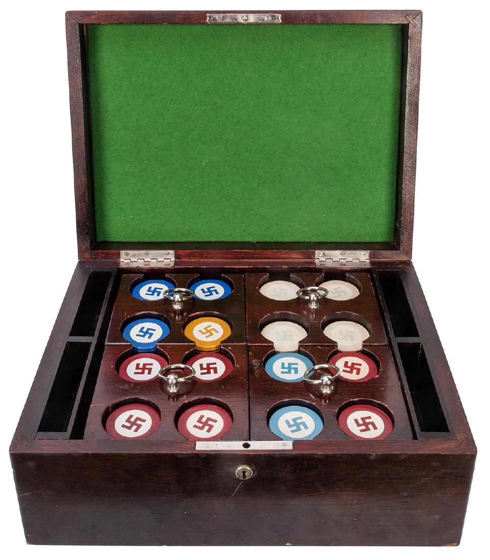 Cased Set of Swastika Design Poker Chips in Racks.: Cased Set of Swastika Design Poker Chips in Racks. Early twentieth century lacquered walnut box with four caddies holding poker chips in red, yellow, blue, and gold. Side slots for four decks of cards