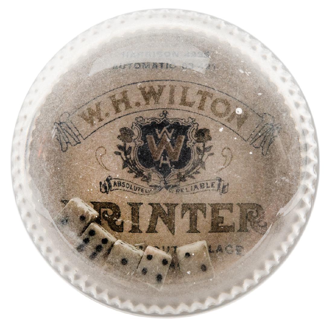 Publicity Glass Dice Game Paperweight.: Publicity Glass Dice Game Paperweight. Chicago: W.H. Wilton Printer, ca. 1900s. Dice shaker also serves as paperweight. Interior gold metallic text. 3” in diameter. Stamped underneath “Pat. 1903��