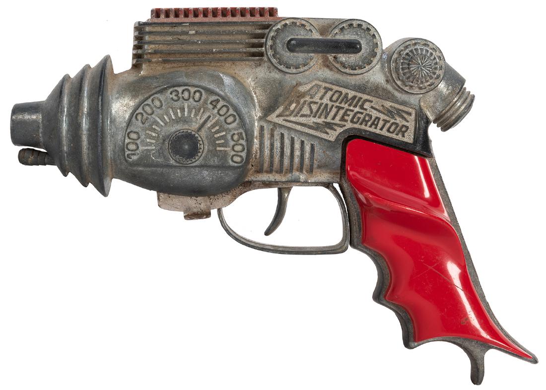 Atomic Disintegrator Repeating Cap Pistol. Lancaster,: Atomic Disintegrator Repeating Cap Pistol. Lancaster, Penn.: Hubley Manufacturing Co., ca. 1940s. A die-cast toy cap gun with original plastic handles and embossed details. Length 6”. Some oxida