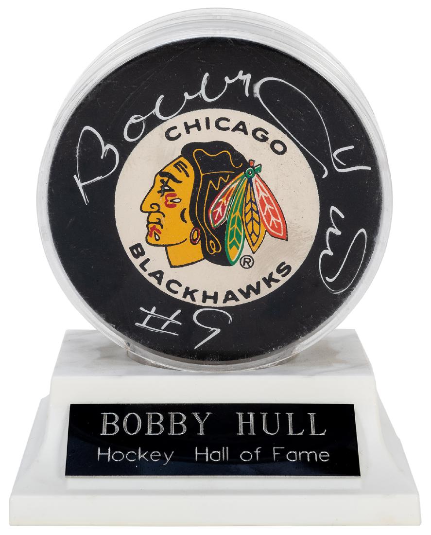 Bobby Hull Signed Hockey Puck. An official NHL rubber (1 of 2)