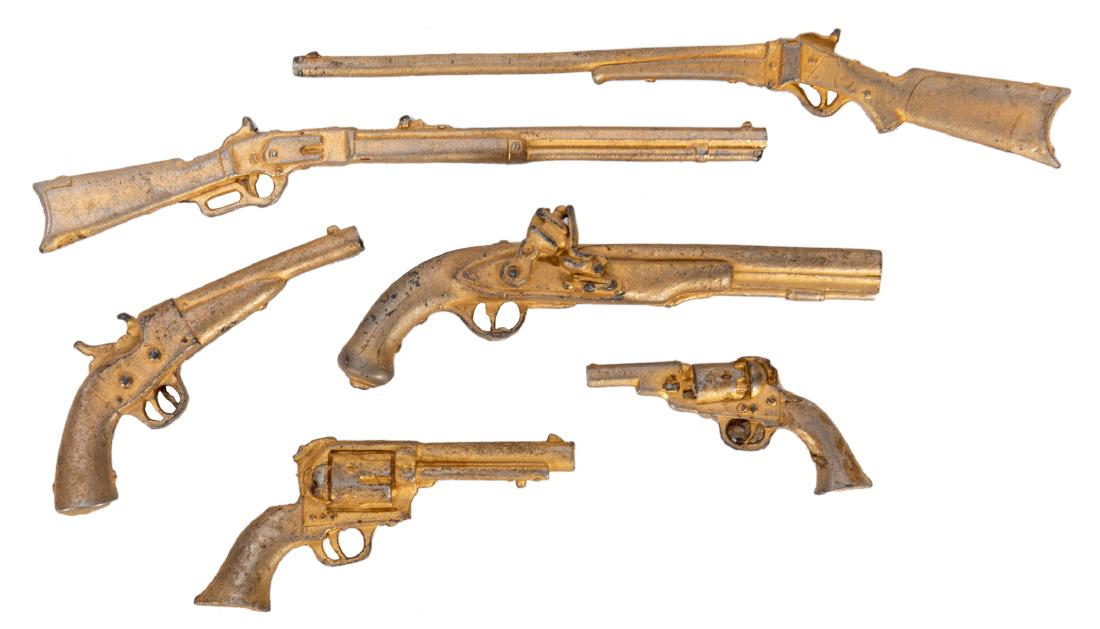 Gabby Hayes Miniature Western Gun Collection. 6 pcs.: Gabby Hayes Miniature Western Gun Collection. 6 pcs. 1951. Gold accent cast metal guns include Gabby Hayes Single Action Six Shooter, Sharps Creedmore Buffalo Gun, Harper’s Ferry Martial Flintlo