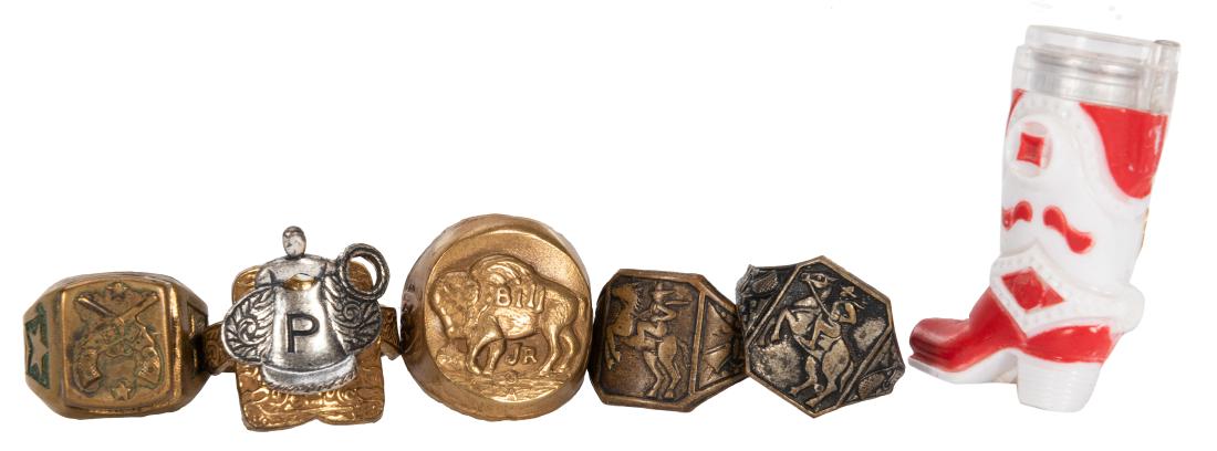 Western Themed Premium Rings. 6 pcs. Circa 1950s. Group: Western Themed Premium Rings. 6 pcs. Circa 1950s. Group includes Popside cowboy boot ring, Mars Candy Buffalo Bill Jr. ring, two-toned saddle ring, and various others featuring images of cowboys, hors