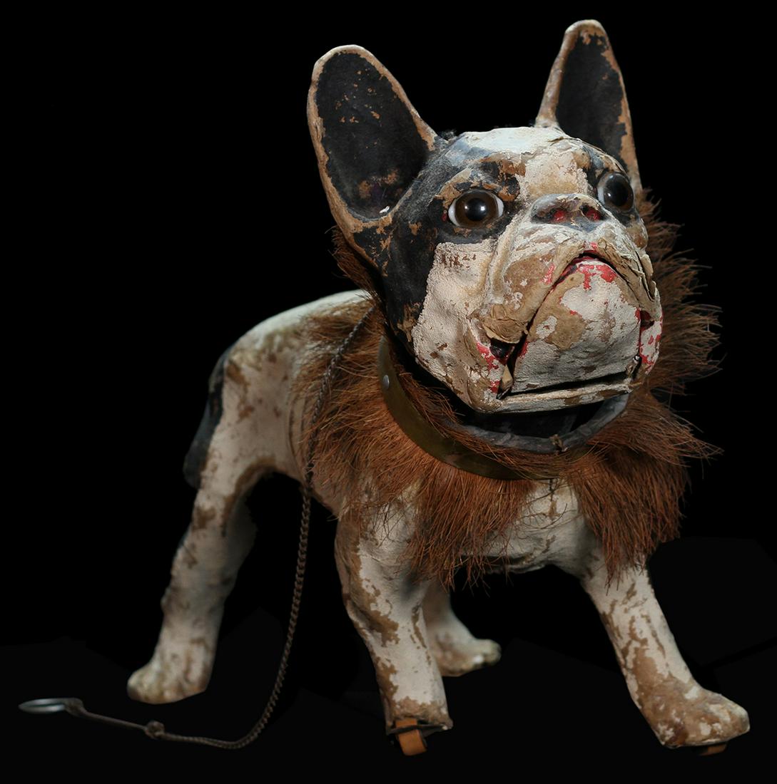 Growling Bulldog Nodder.: Growling Bulldog Nodder. Circa 1890. Papier-mache bulldog with glass eyes and roller feet. When the chain attached to the dogÂ’s collar is pulled, its mouth opens and the dog barks. Exterior well w