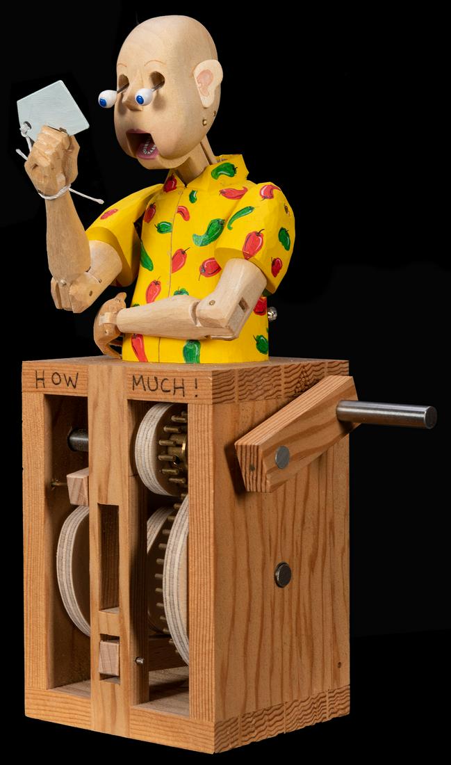How Much! Automaton.: How Much! Automaton. Fourteen Balls/Matt Smith, 2014. Wooden mechanical automaton with exposed works. A man brings a price tag up to reading position and his eyes bulge out completely from their socke