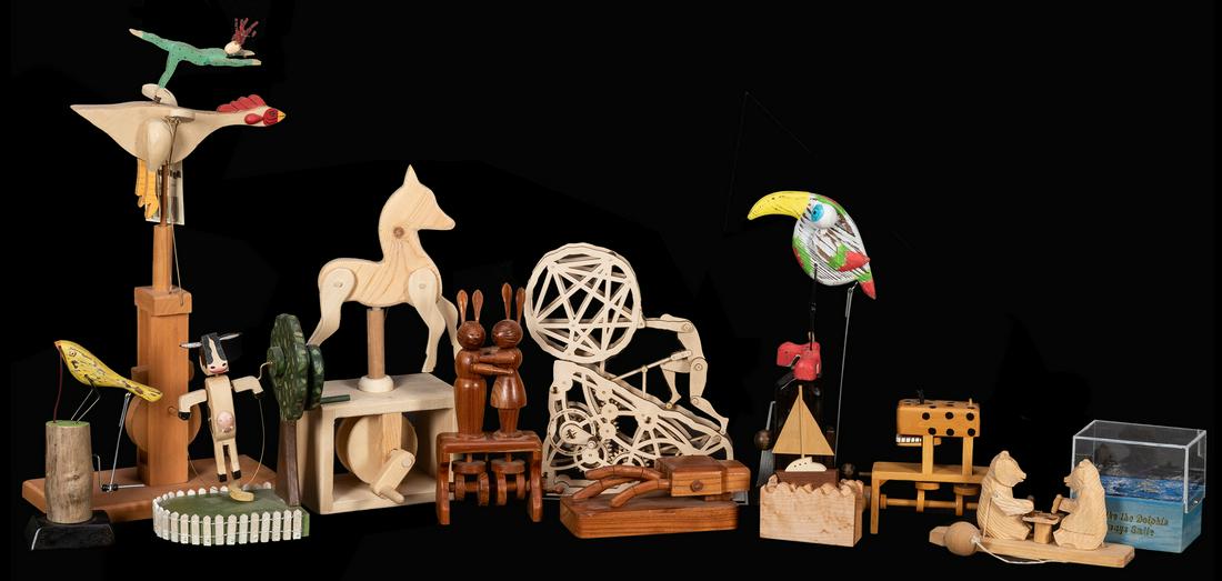 Dozen Whimsical Wooden Automatons / Kinetic Sculptures.: Dozen Whimsical Wooden Automatons / Kinetic Sculptures. Contemporary wooden automata including a rapping hand, kissing rabbits, cow jumping over the Moon, chess-playing bears, Parrot in Boots (Richard