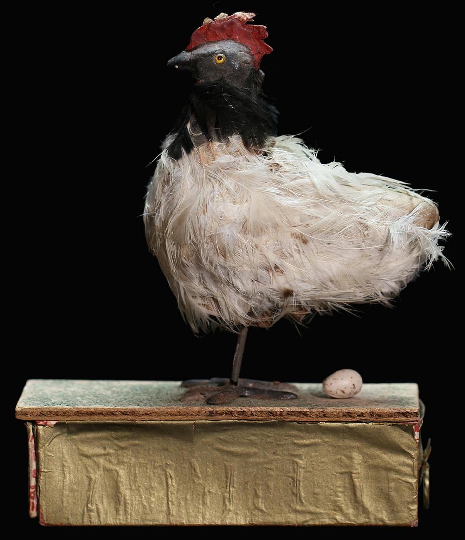 Egg-Laying Chicken Toy.: Egg-Laying Chicken Toy. Circa late nineteenth century. Drop eggs into the back of the neck, press down on the body, and the chicken begins laying eggs. Papier-mache body and head, covered with real bi