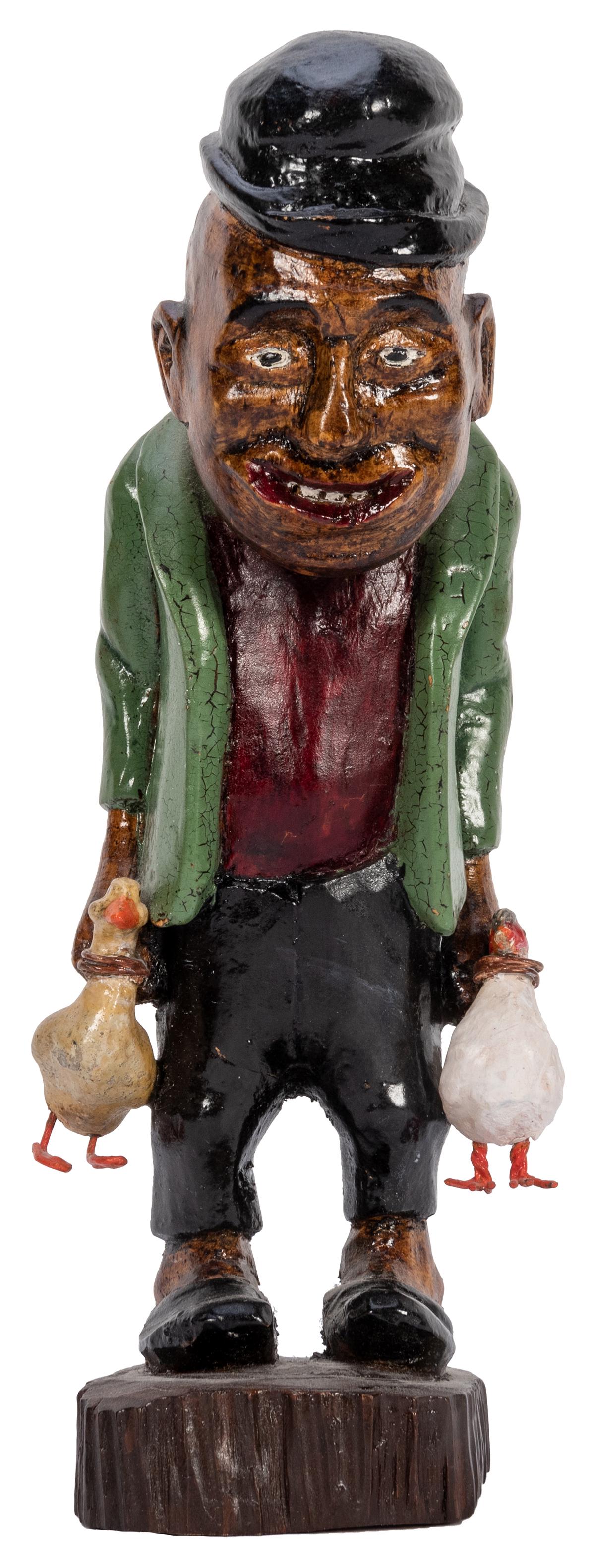 Black Americana Carved Wooden Figure.: Black Americana Carved Wooden Figure. Hand painted folk-art statue of a grinning elderly African American man holding a duck and a chicken that he recently captured. Height 9”. Minor paint crack